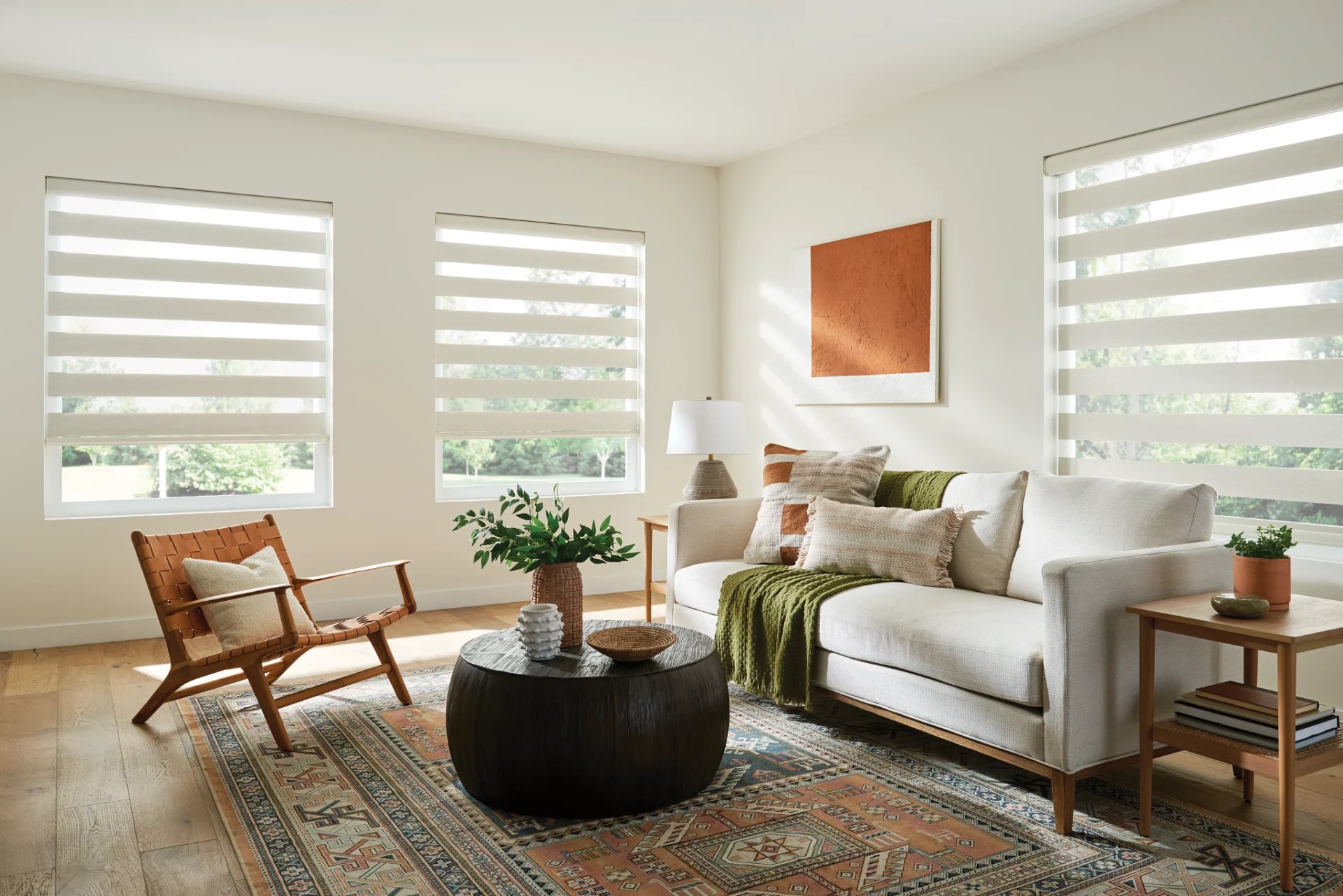 A living room with white furniture and a table